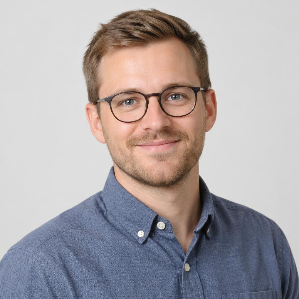 Young Norwegian man with glasses, studio portrait
